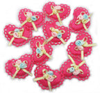 Close-up of a bright pink heart trim featuring a bow and floral design.