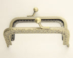 Close-up of the kiss clasp lock on the purse frame