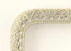 Squared metal purse frame showcasing perforations and design