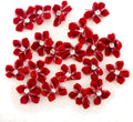 Red velvet flower trim with diamante centre on a white background.