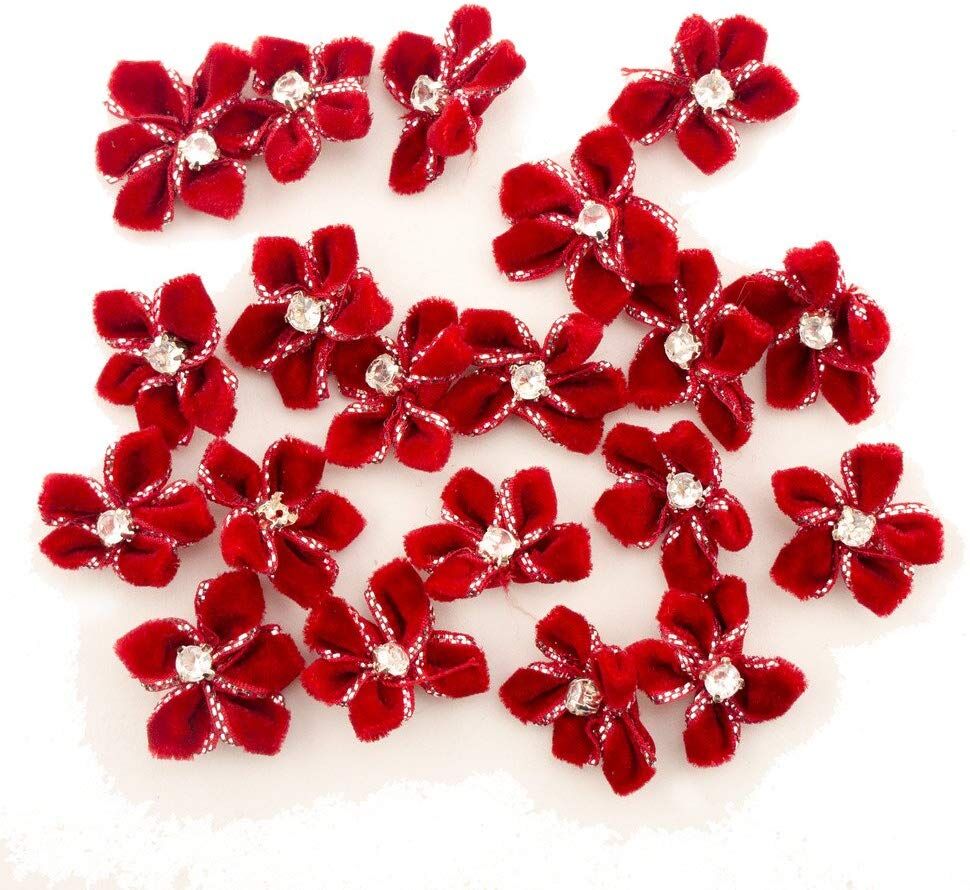 Red velvet flower trim with diamante centre on a white background.