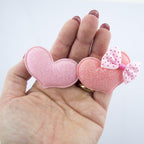 Close-up of a polka dot bow hairclip barrette in pastel colours.