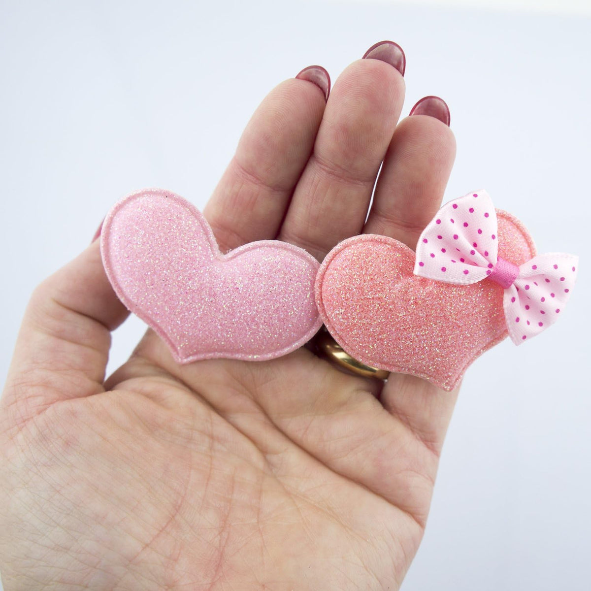Close-up of a polka dot bow hairclip barrette in pastel colours.
