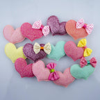 Display of four hairclip barrettes with sparkly hearts and polka dots.
