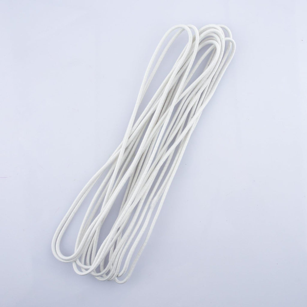 Black round sewing elastic displayed with sewing tools