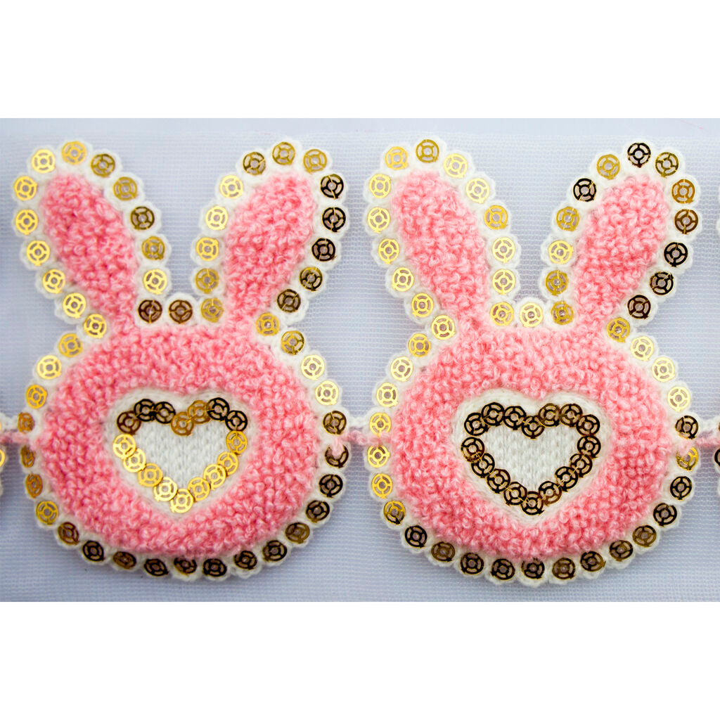 Close-up of sequins on the pink bunny and heart decorative trim.