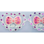 Decorative trim with net backing and purple sequins.