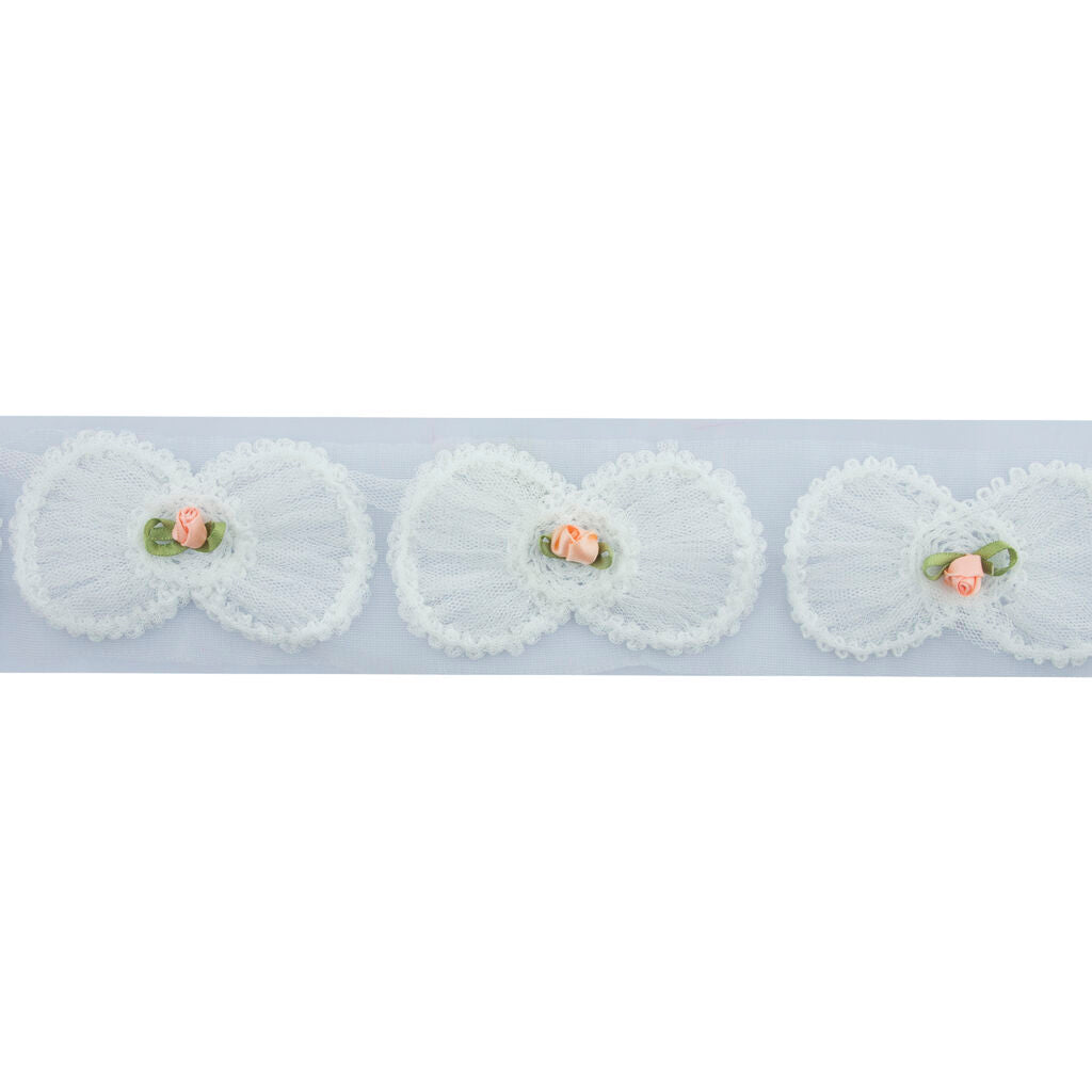 Close-up of white bow and pink flower decorative trim.