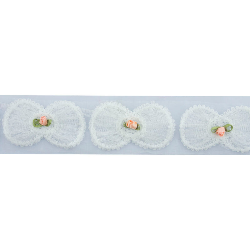 Close-up of white bow and pink flower decorative trim.