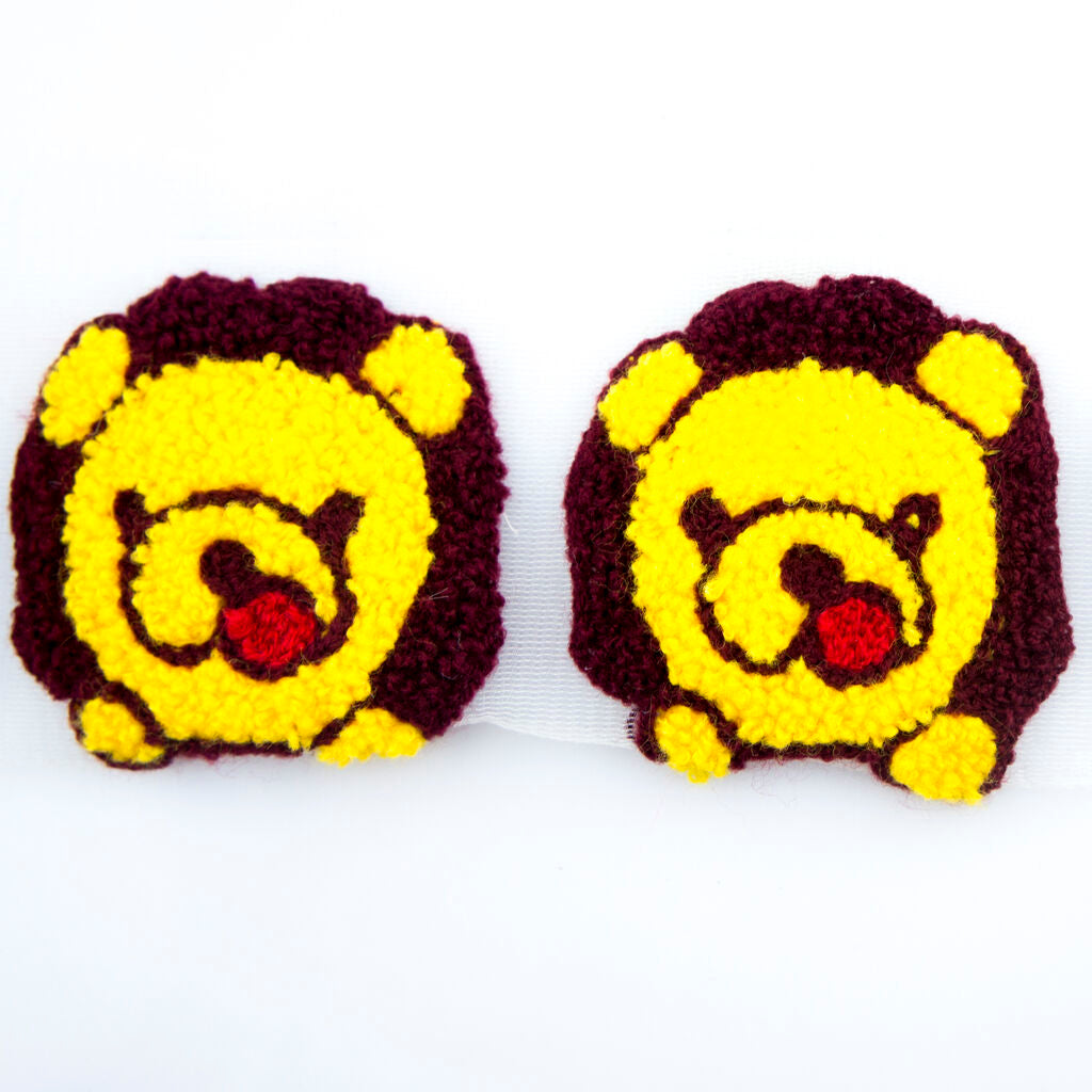 Seven pieces of teddy bear decorative trim on a net backing.