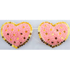 Close-up of pink heart trim with gold sequins on net backing