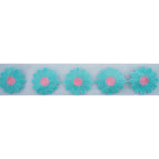 Close-up of blue and pink knitted flower decorative trim on net backing.