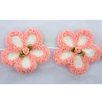 Close-up of the pink flower trim featuring a central ribbon rose.