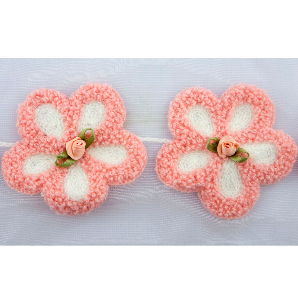 Close-up of the pink flower trim featuring a central ribbon rose.