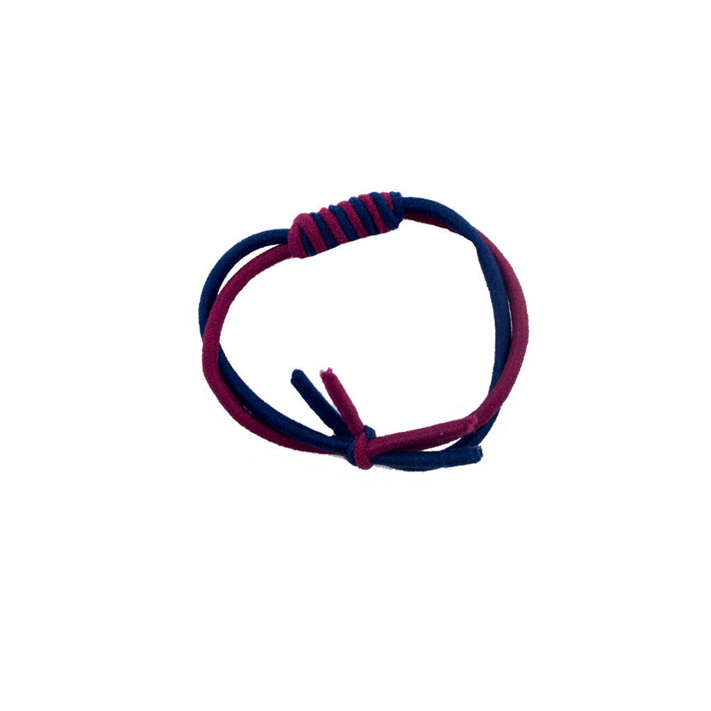 Close-up of a twisting elasticated hair band in navy and burgundy.