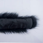 Black and white fake fur collar laid flat on a surface