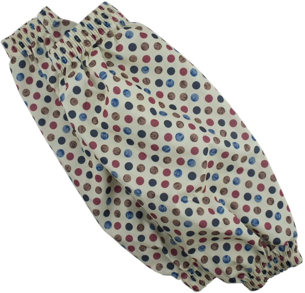 Two pairs of polka dot sleeve protectors displayed on a table.