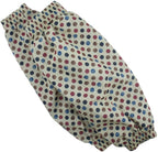 Two pairs of polka dot sleeve protectors displayed on a table.