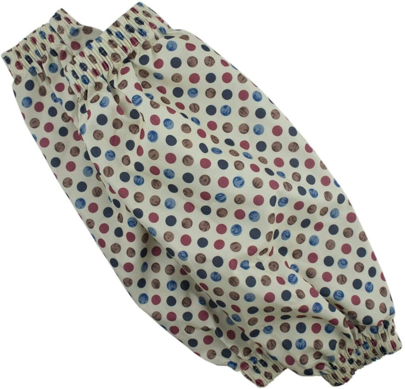 Two pairs of polka dot sleeve protectors displayed on a table.