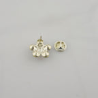 Two white crystal flower brooches displayed together.