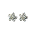 Close-up of a white crystal and silver tone flower brooch.