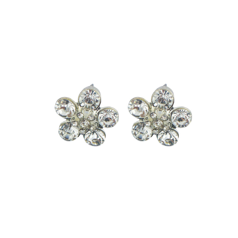 Close-up of a white crystal and silver tone flower brooch.