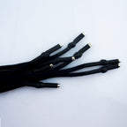 Black hoodie cords laid flat to show their 5 mm diameter.