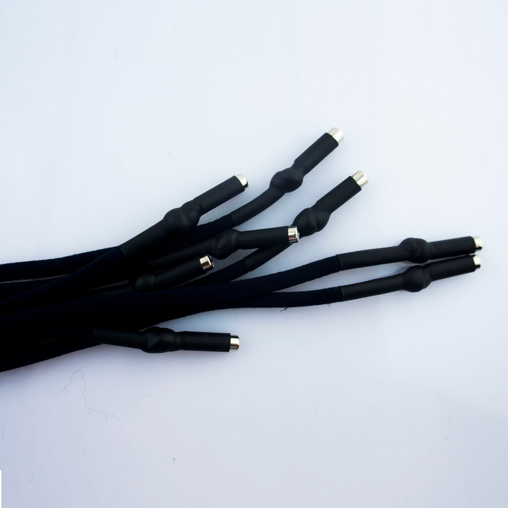 Black hoodie cords laid flat to show their 5 mm diameter.