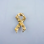 Close-up of the ribbon brooch showcasing clear crystals and gold tone.