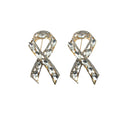 Stylish ribbon brooch with clear crystals in gold tone setting.