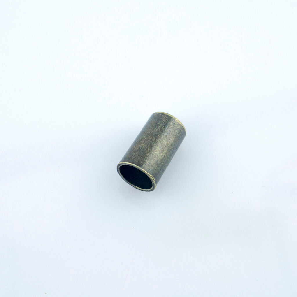 Close-up of a metal cord end, 16 x 8 mm, ideal for drawstrings.