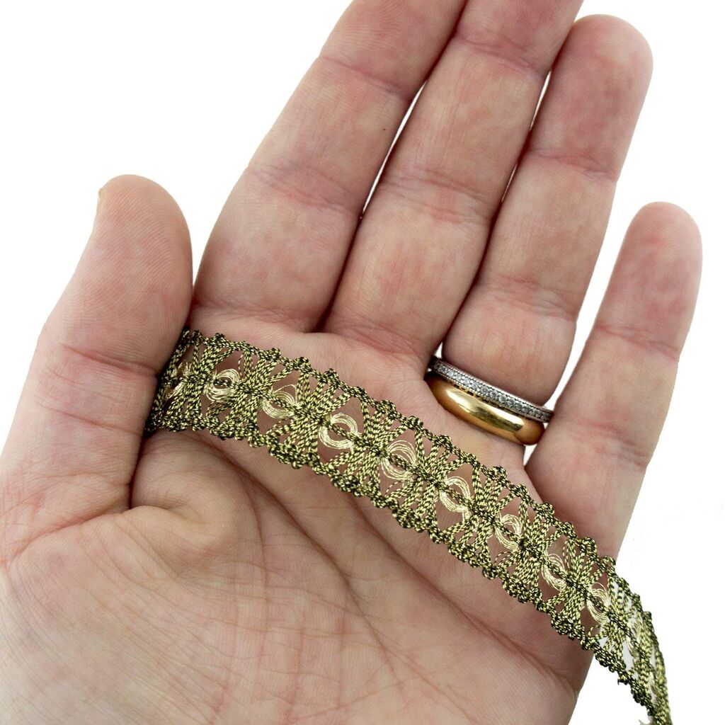 Close-up of 15 mm wide antique gold metallic trim for sewing projects.