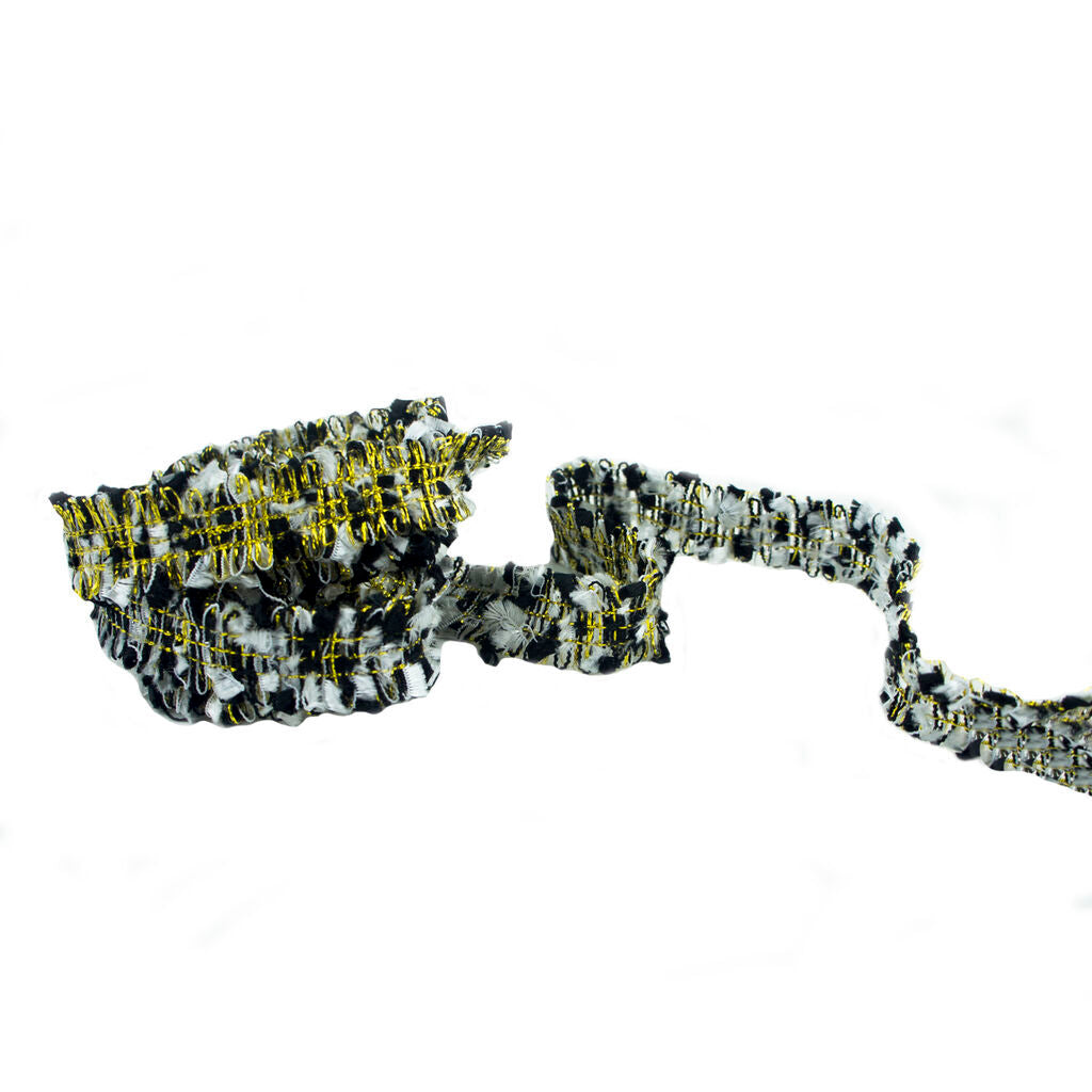 Close-up of the black white and gold embellishment trim for garments.