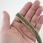 Close-up view of the metallic embellishment trim showcasing its texture.
