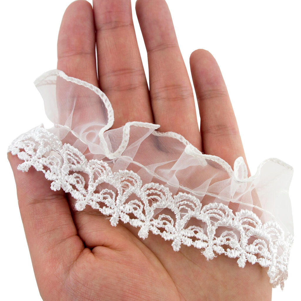 Roll of white viscose lace organza ruffle trim displayed on a flat surface.