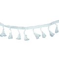 White cotton tassel trim displayed on a flat surface.