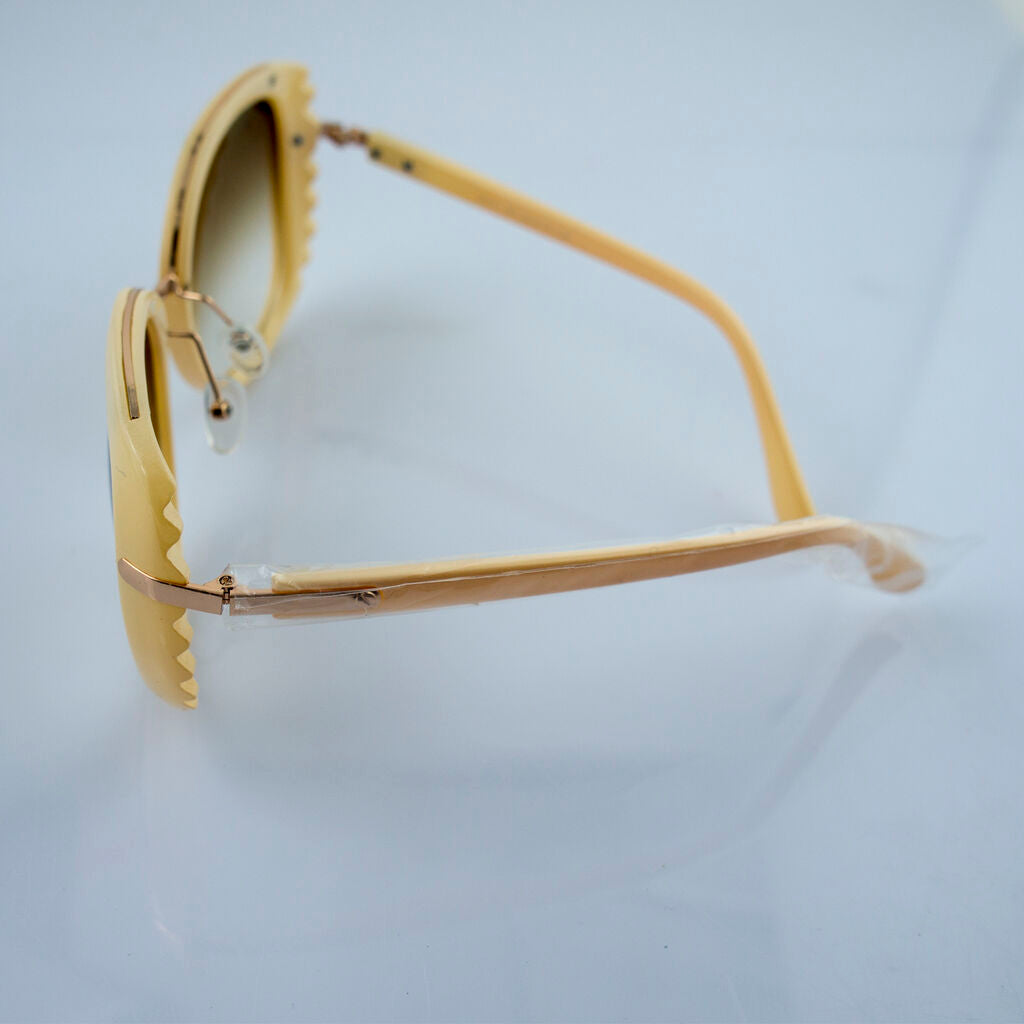 Close-up of the detailed trim on the nude frame sunglasses.