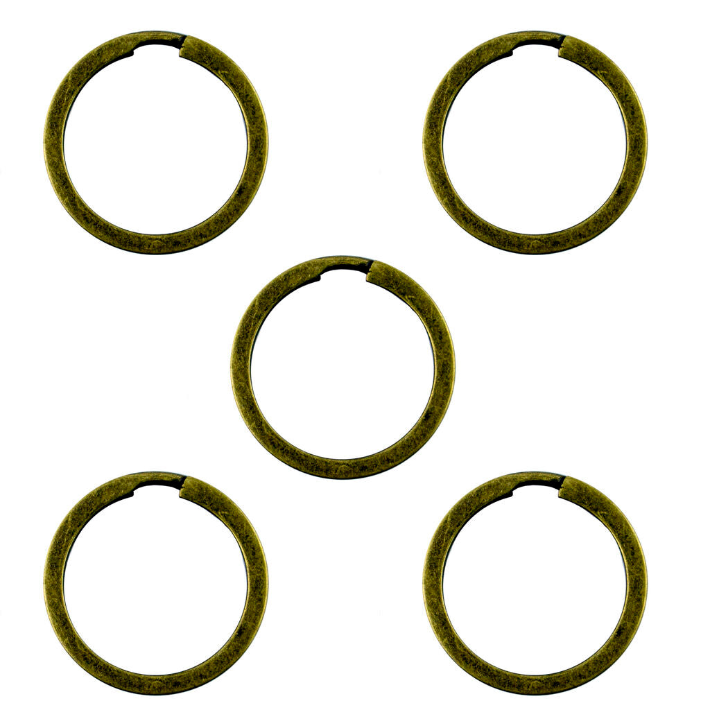 Five vintage gold tone metal keyrings displayed together.
