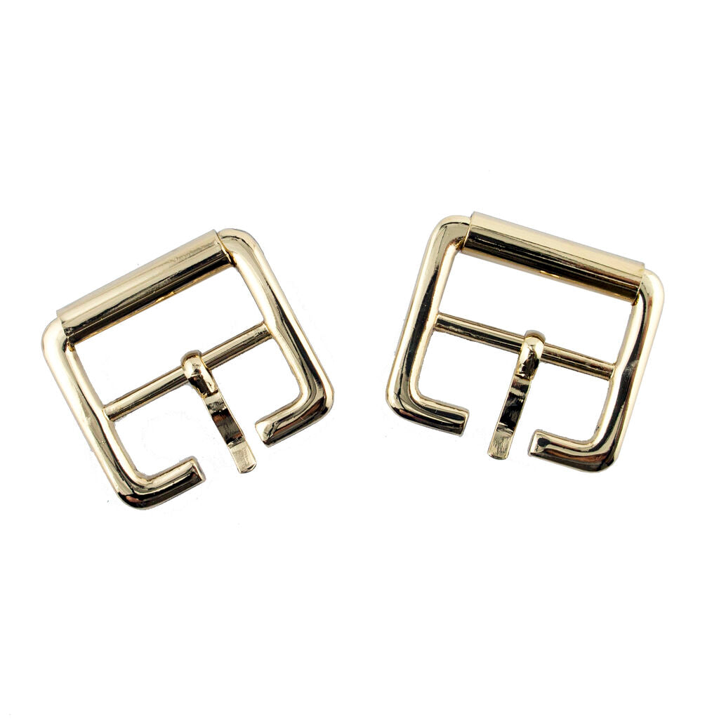 Close-up of a light shiny gold square metal buckle showing detail.