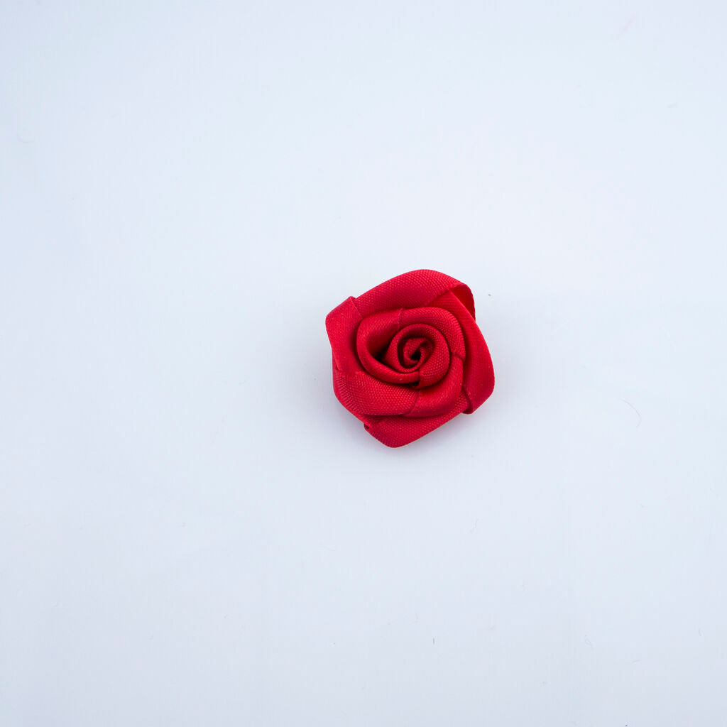 Close-up of deep red rose ribbon trims showing intricate details.