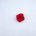 Close-up of deep red rose ribbon trims showing intricate details.