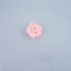 Close-up of 21 mm baby pink rose ribbon trims in a pack.