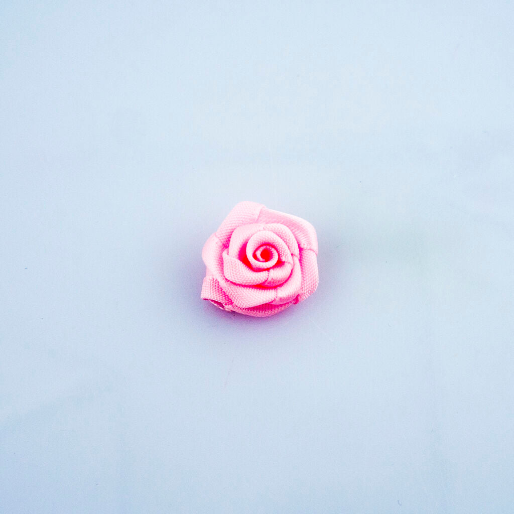 Close-up of 17 mm baby pink rose ribbon trim on a soft background