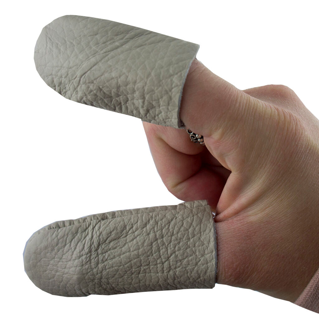 Two pairs of men's leather thimble protectors for crafting.