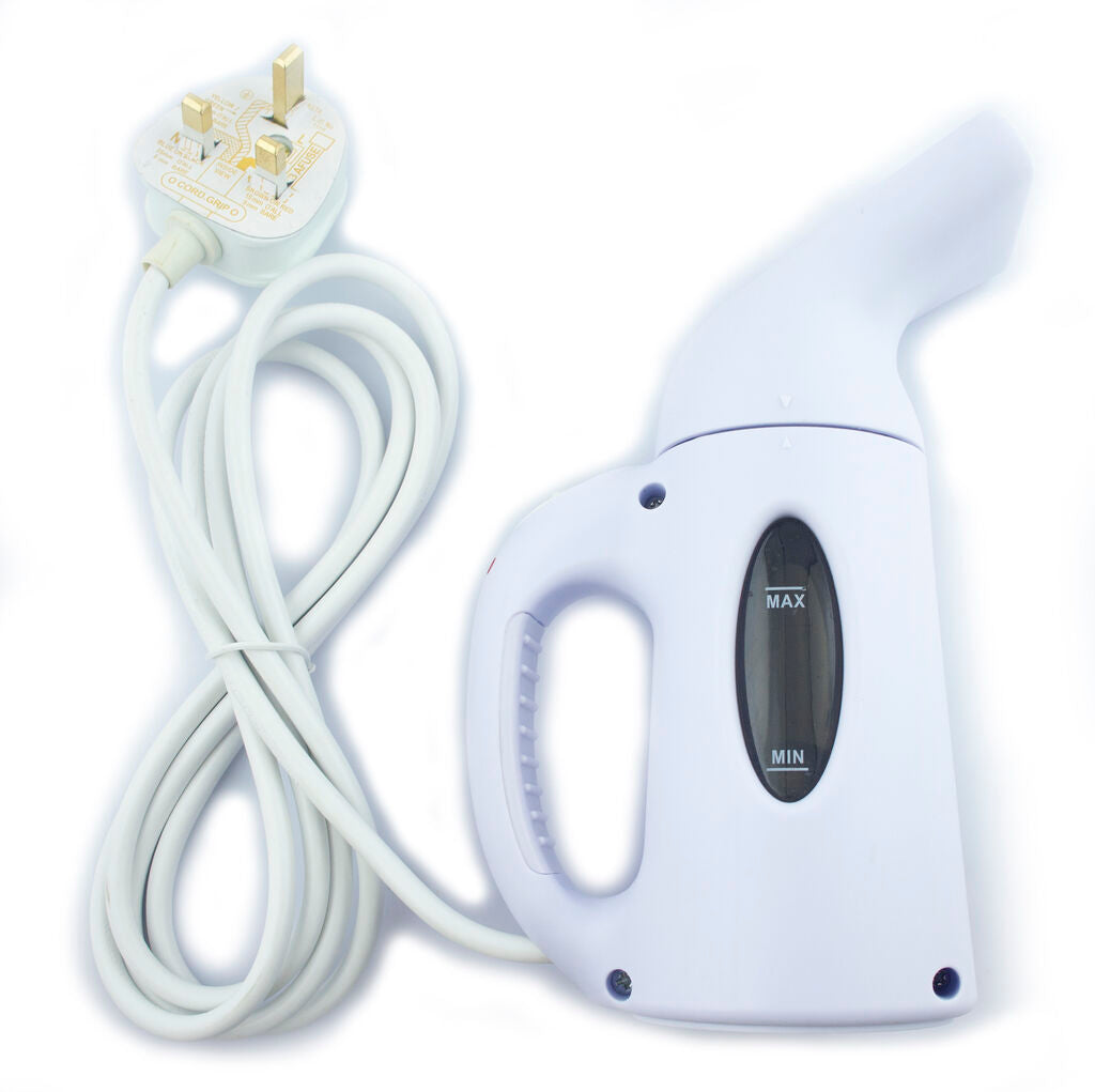 Steamer placed on a table with clothes ready for ironing