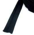 Black sleeve head roll displayed on a flat surface.