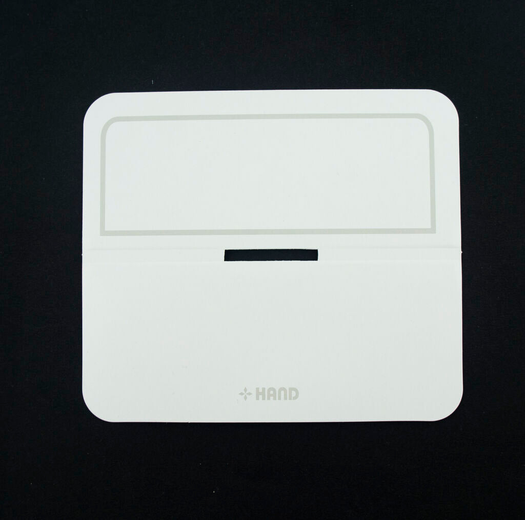 Close-up of a folded white header card with printed border