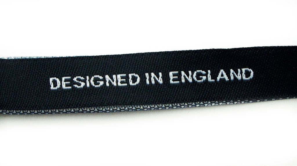 Labels displayed on fabric showcasing their use in garments.