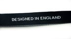 Labels displayed on fabric showcasing their use in garments.