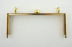 Close-up of the ball clasp on the gold shoulder bag frame